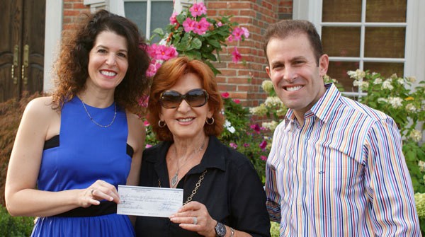 image: Granovskys give check to Beit Halochem Canada